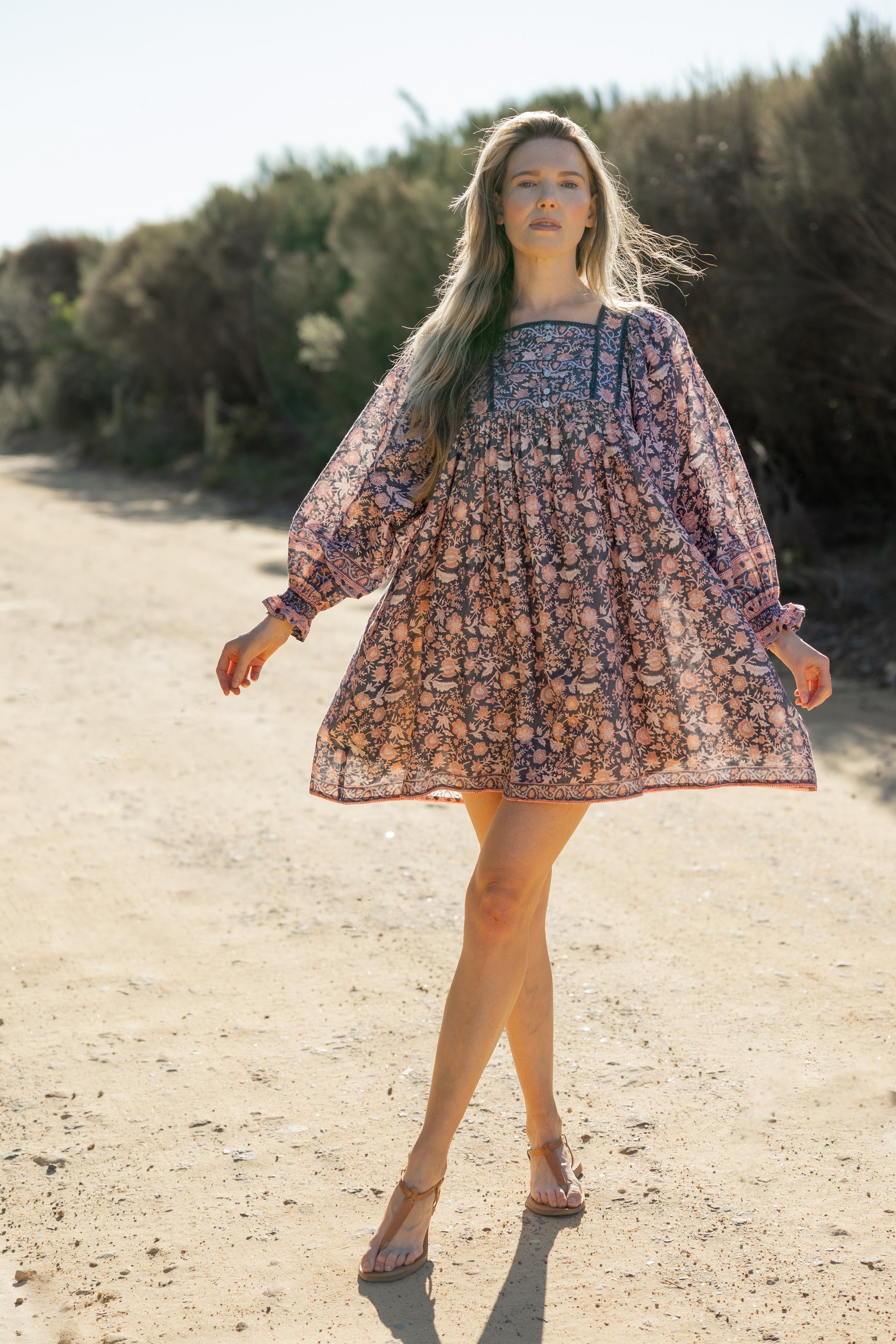 Made by Mortals women’s Jardin de Rose Mini Dress with billowy sleeves, hand block printed cotton bohemian dress in black with white, blue and pink floral pattern.
