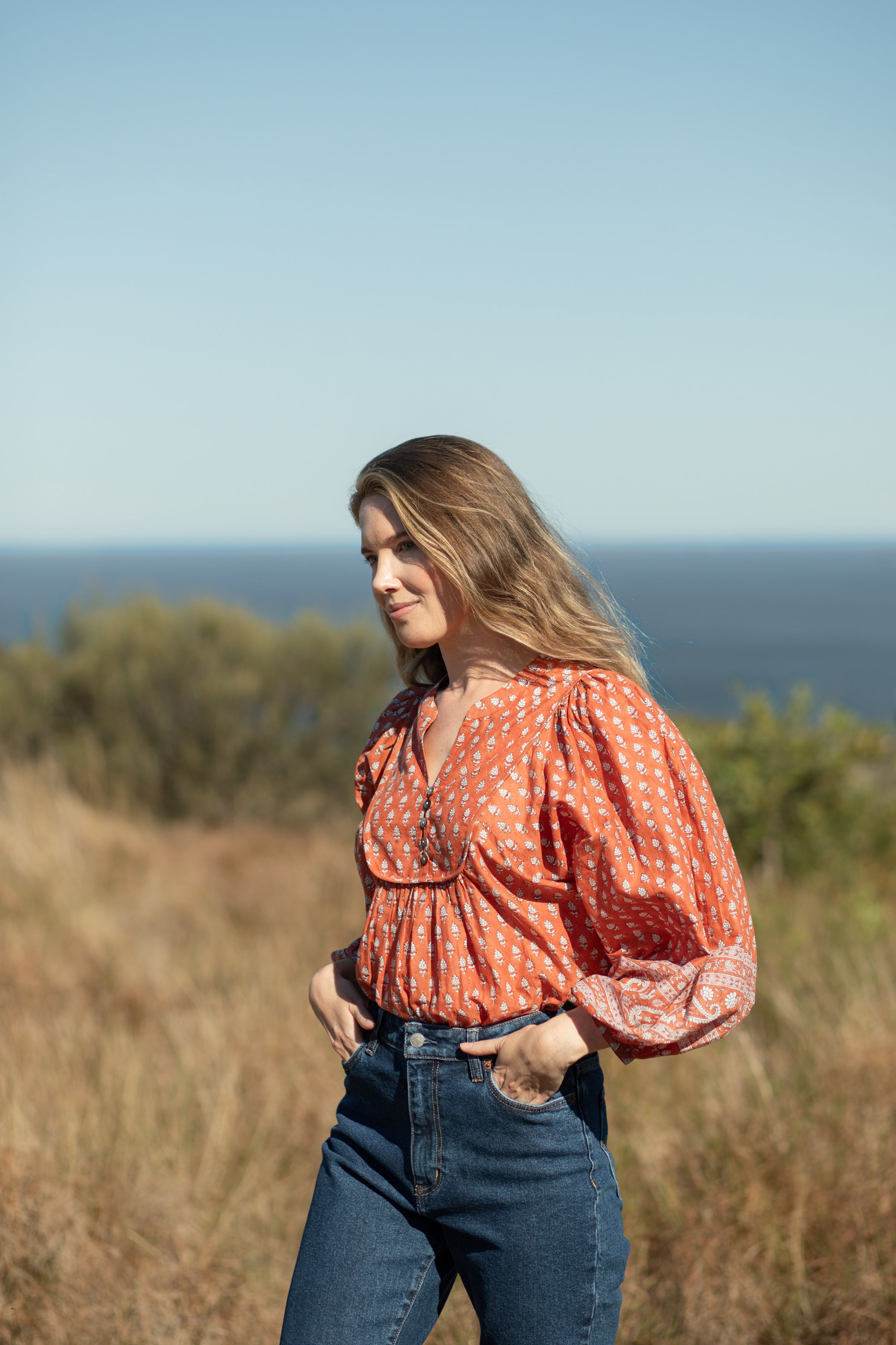 Made by Mortals women’s Desert Bloom Blouse with billowy sleeves, hand block printed bohemian cotton blouse in rust.