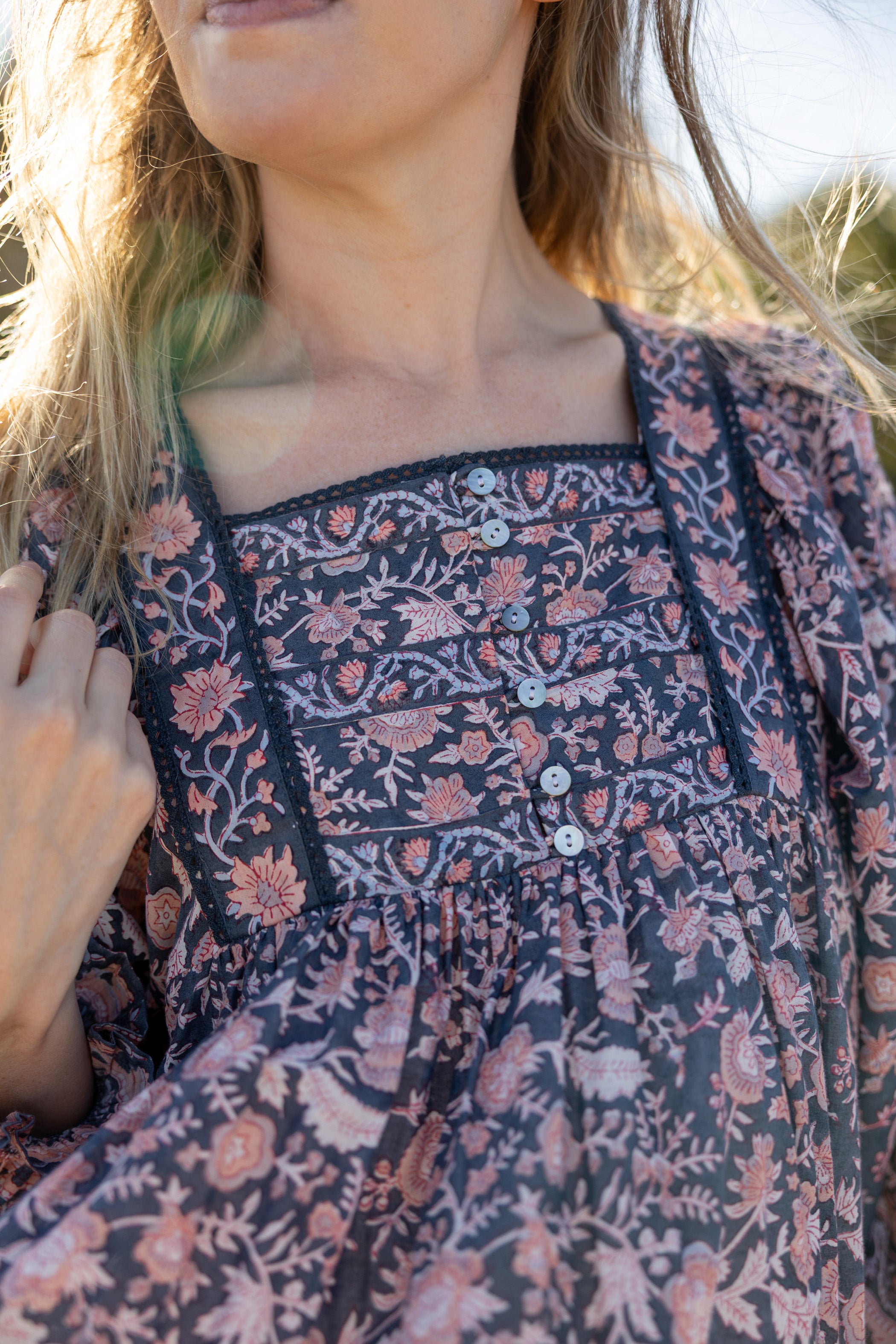 Made by Mortals women’s Jardin de Rose Mini Dress with billowy sleeves, hand block printed cotton bohemian dress in black with white, blue and pink floral pattern.