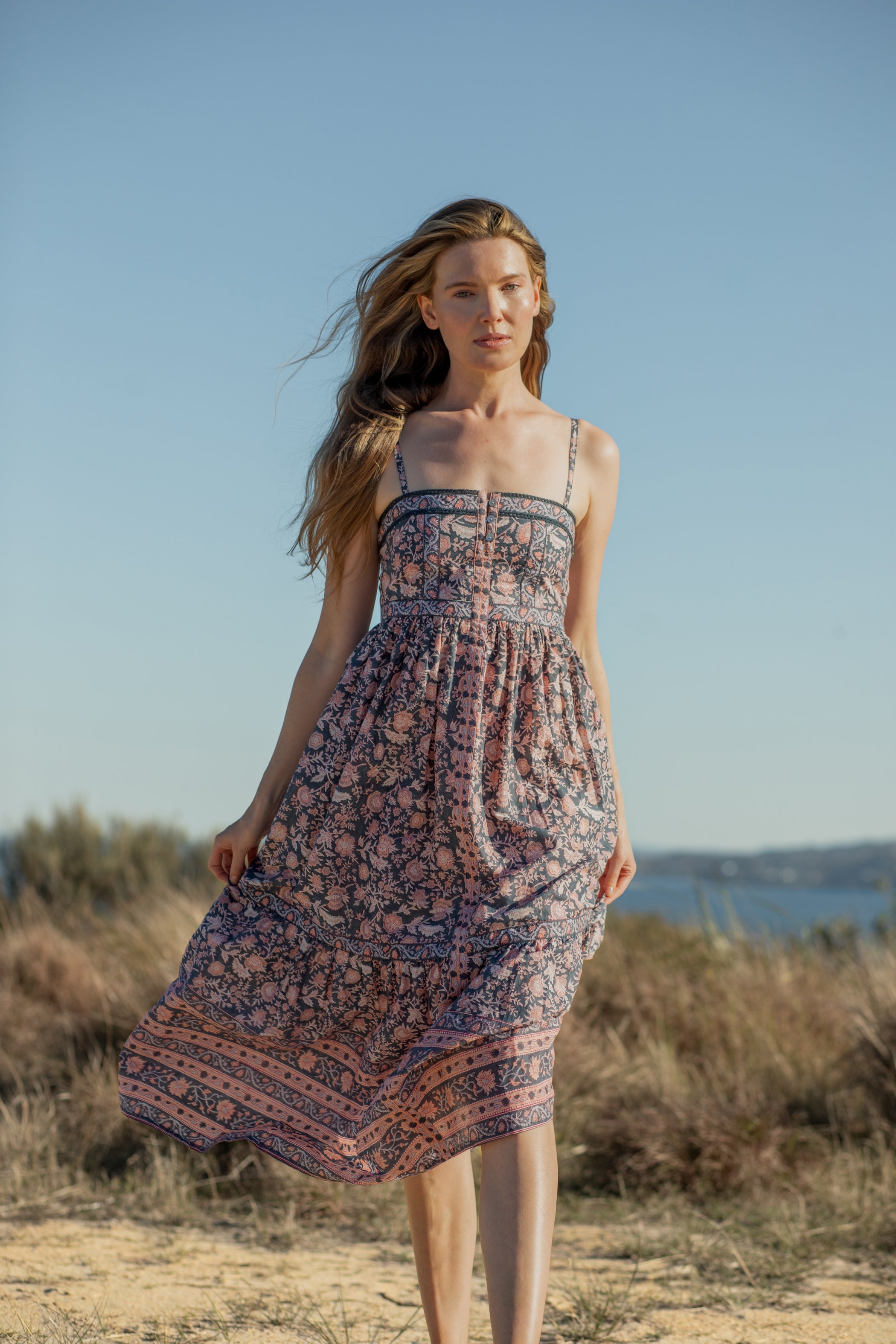 Made by Mortals women’s Jardin de Rose Midi Dress, bohemian strappy dress in black with white, blue, and pink floral, hand block printed cotton.