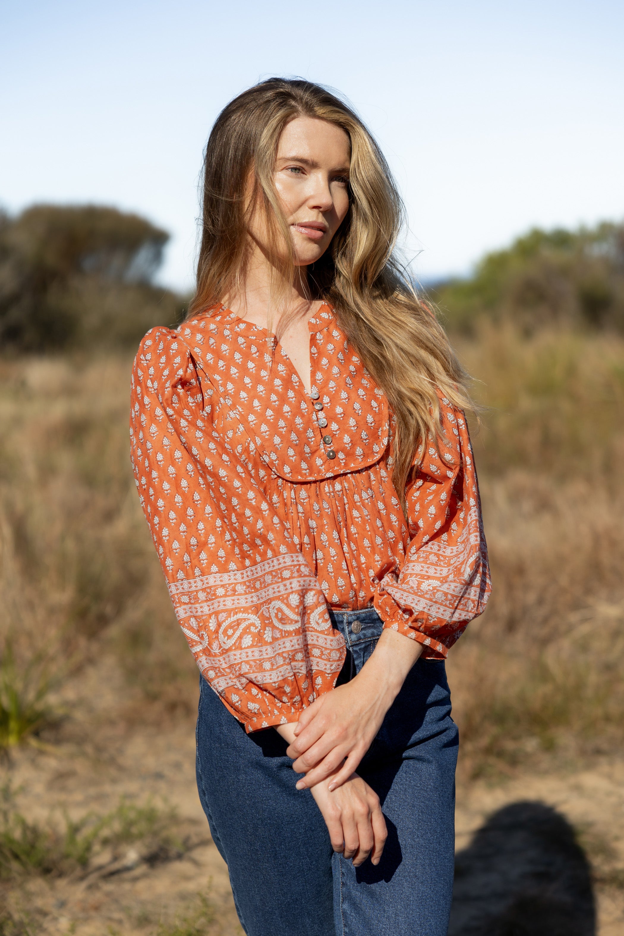 Made by Mortals women’s Desert Bloom Blouse with billowy sleeves, hand block printed bohemian cotton blouse in rust.