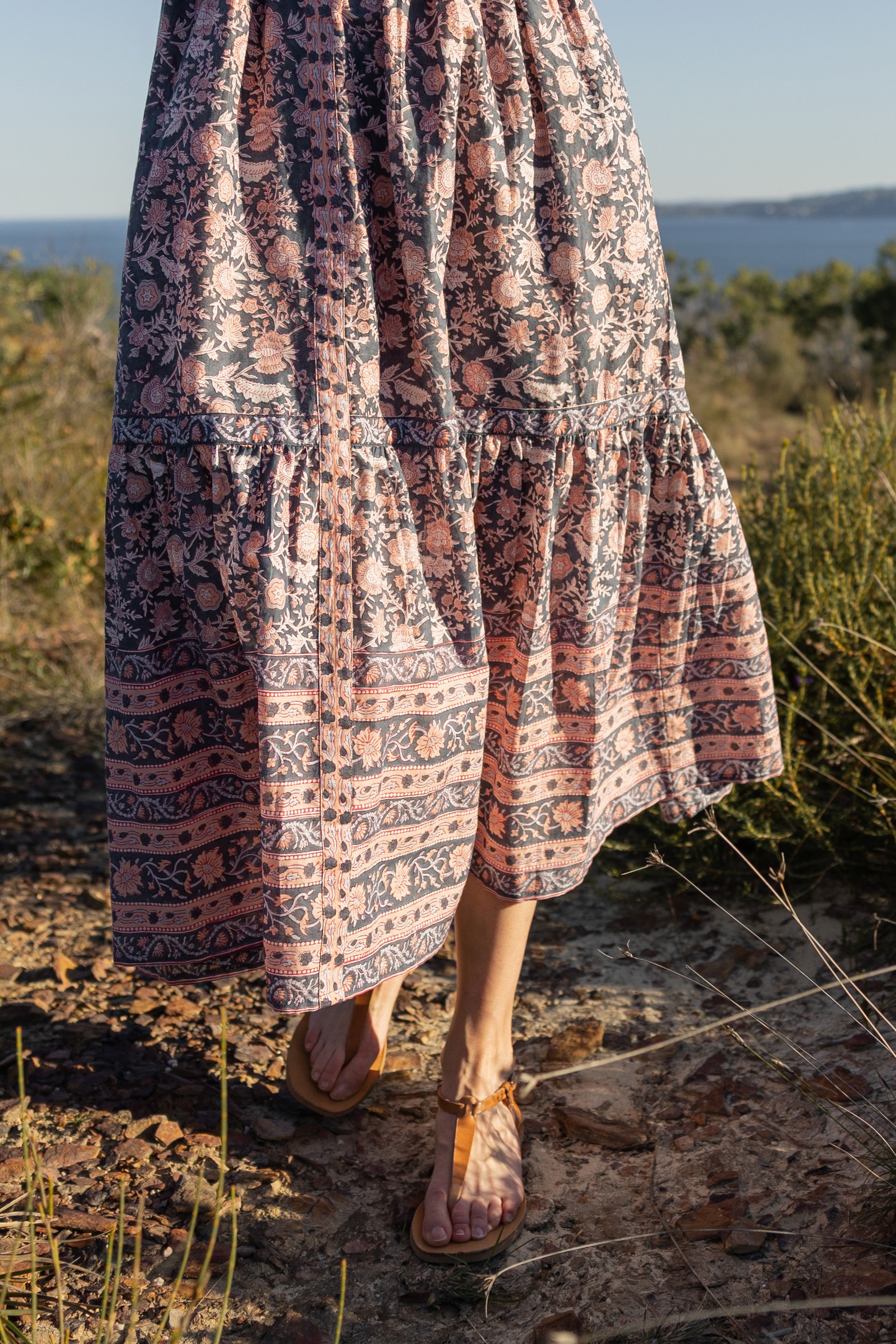 Made by Mortals women’s Jardin de Rose Midi Dress, bohemian strappy dress in black with white, blue, and pink floral, hand block printed cotton.