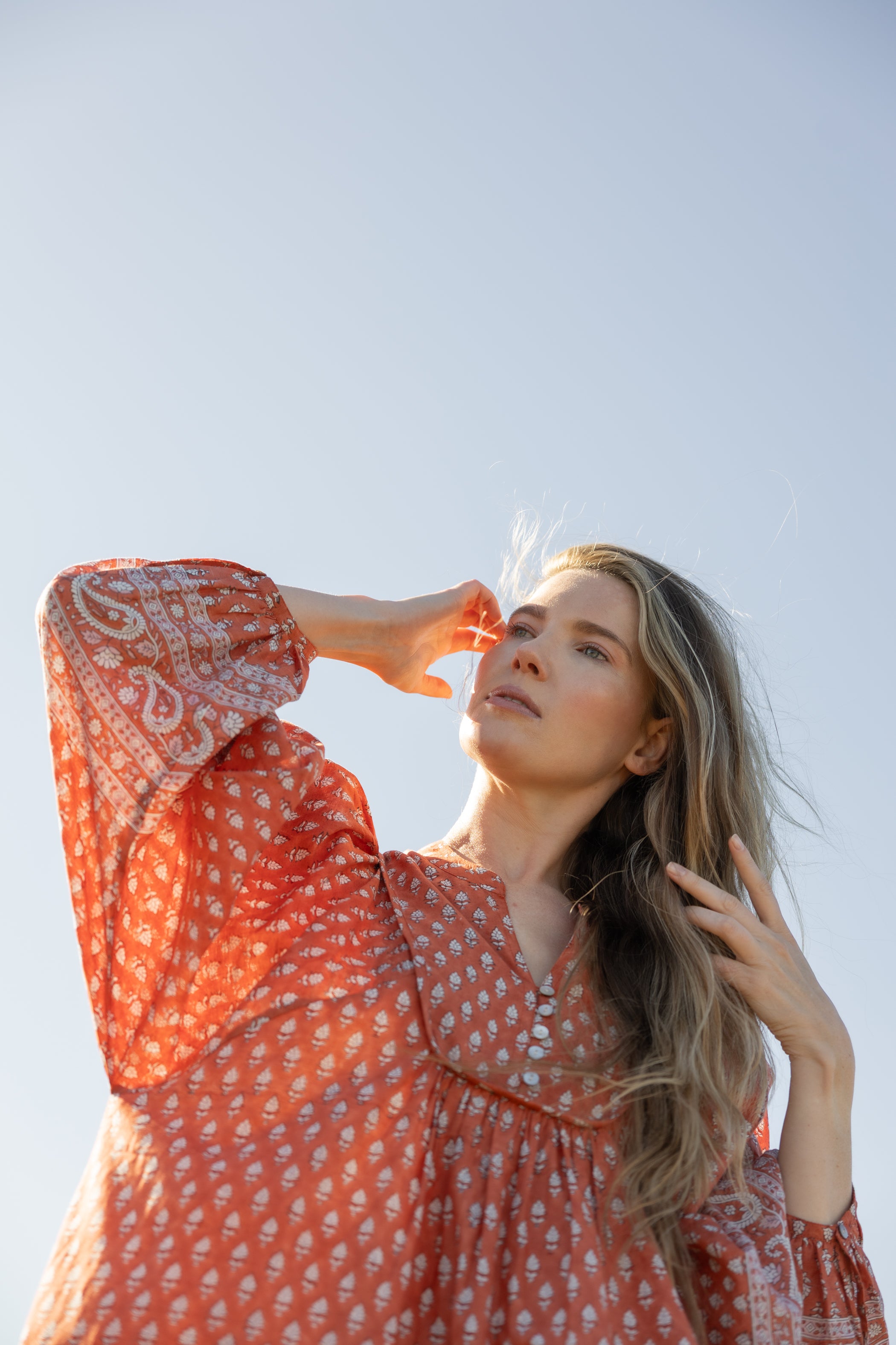 Made by Mortals women’s Desert Bloom Midi Dress in rust with billowy sleeves, hand block printed cotton bohemian dress by artisans in India.