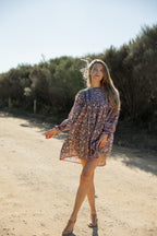 Made by Mortals women’s Jardin de Rose Mini Dress with billowy sleeves, hand block printed cotton bohemian dress in black with white, blue and pink floral pattern.