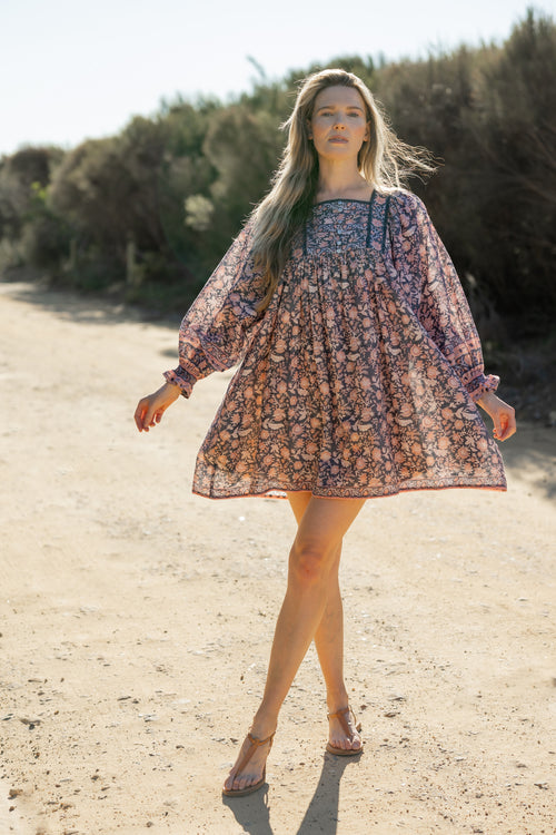 Made by Mortals women’s Jardin de Rose Mini Dress with billowy sleeves, hand block printed cotton bohemian dress in black with white, blue and pink floral pattern.