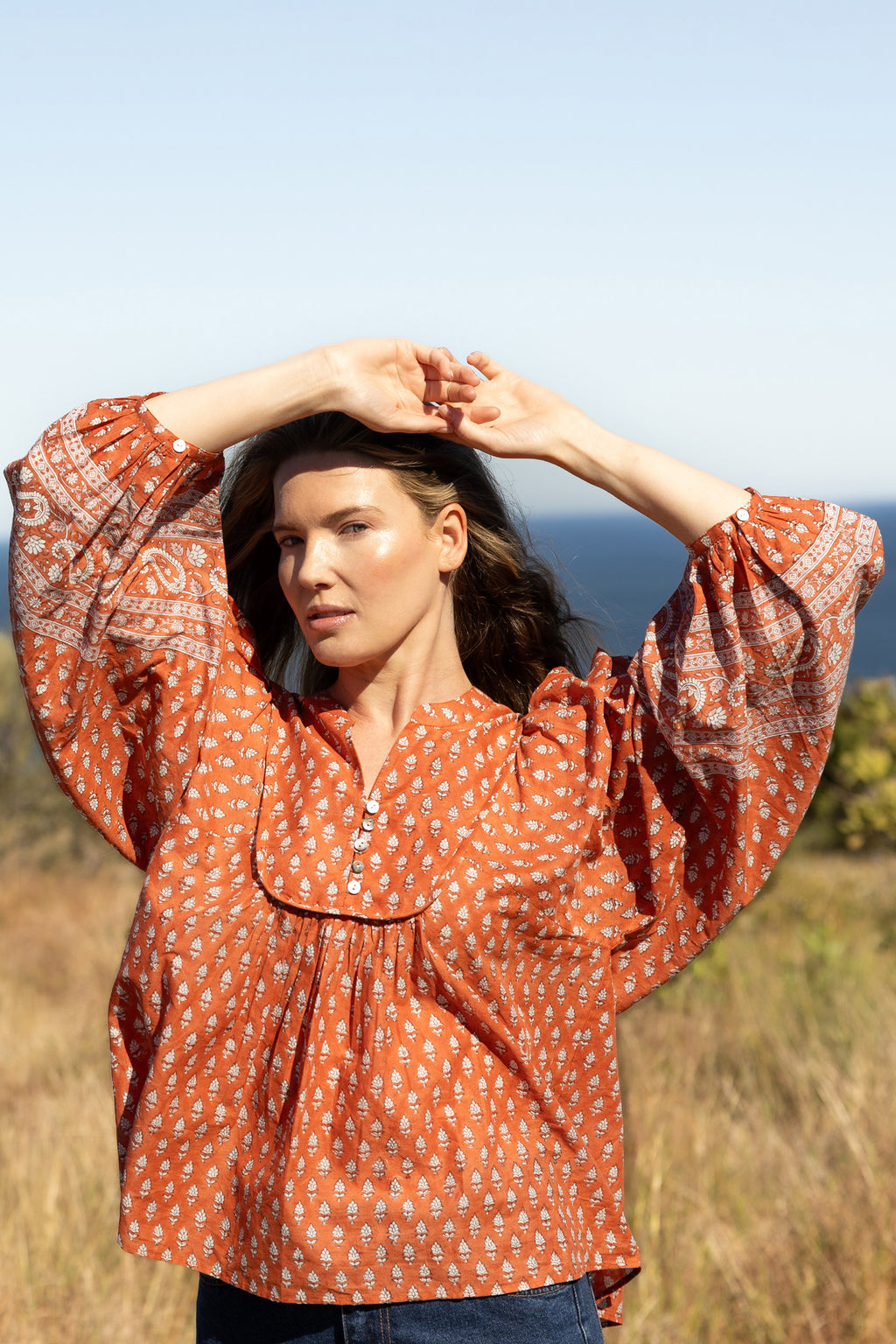 Made by Mortals women’s Desert Bloom Blouse with billowy sleeves, hand block printed bohemian cotton blouse in rust.