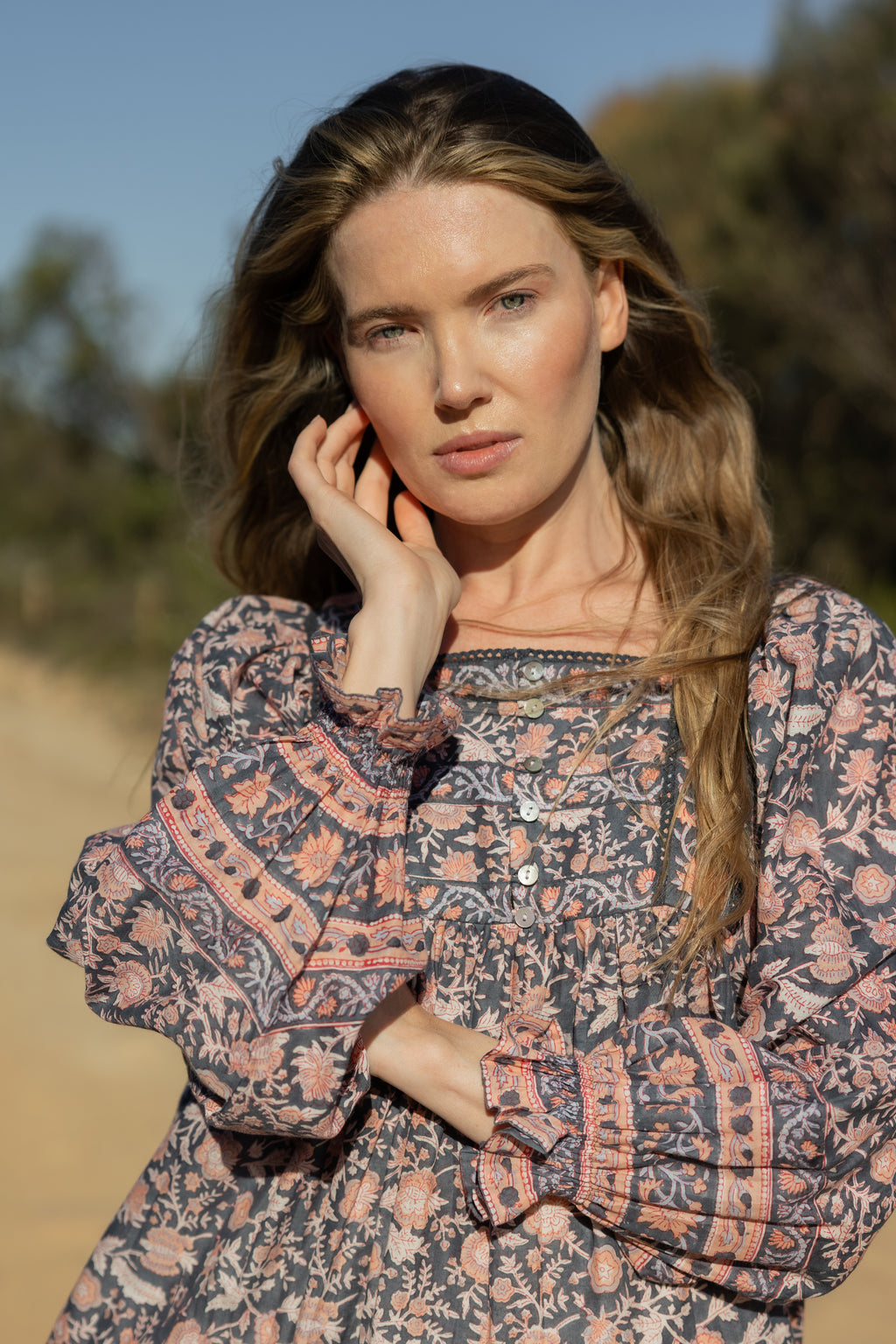 Made by Mortals women’s Jardin de Rose Mini Dress with billowy sleeves, hand block printed cotton bohemian dress in black with white, blue and pink floral pattern.