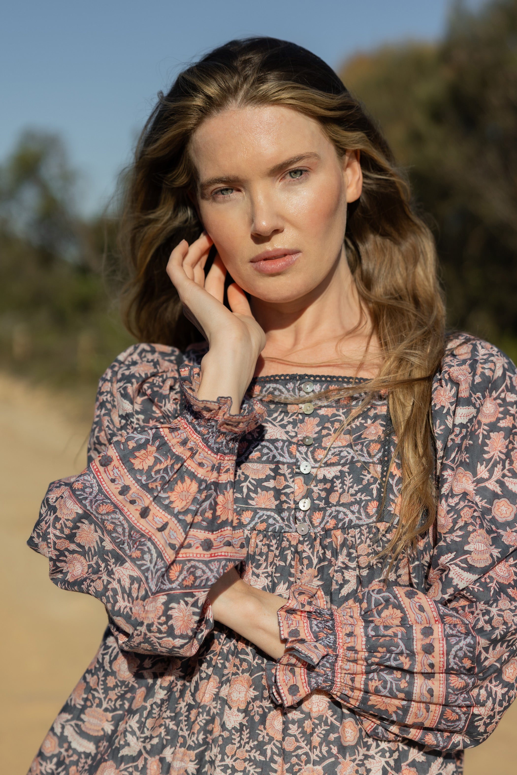 Made by Mortals women’s Jardin de Rose Mini Dress with billowy sleeves, hand block printed cotton bohemian dress in black with white, blue and pink floral pattern.