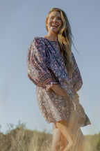 Made by Mortals women’s Jardin de Rose Mini Dress with billowy sleeves, hand block printed cotton bohemian dress in black with white, blue and pink floral pattern.