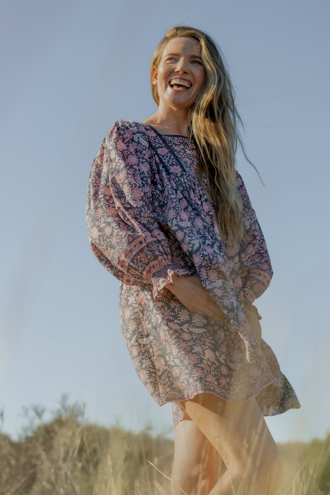 Made by Mortals women’s Jardin de Rose Mini Dress with billowy sleeves, hand block printed cotton bohemian dress in black with white, blue and pink floral pattern.