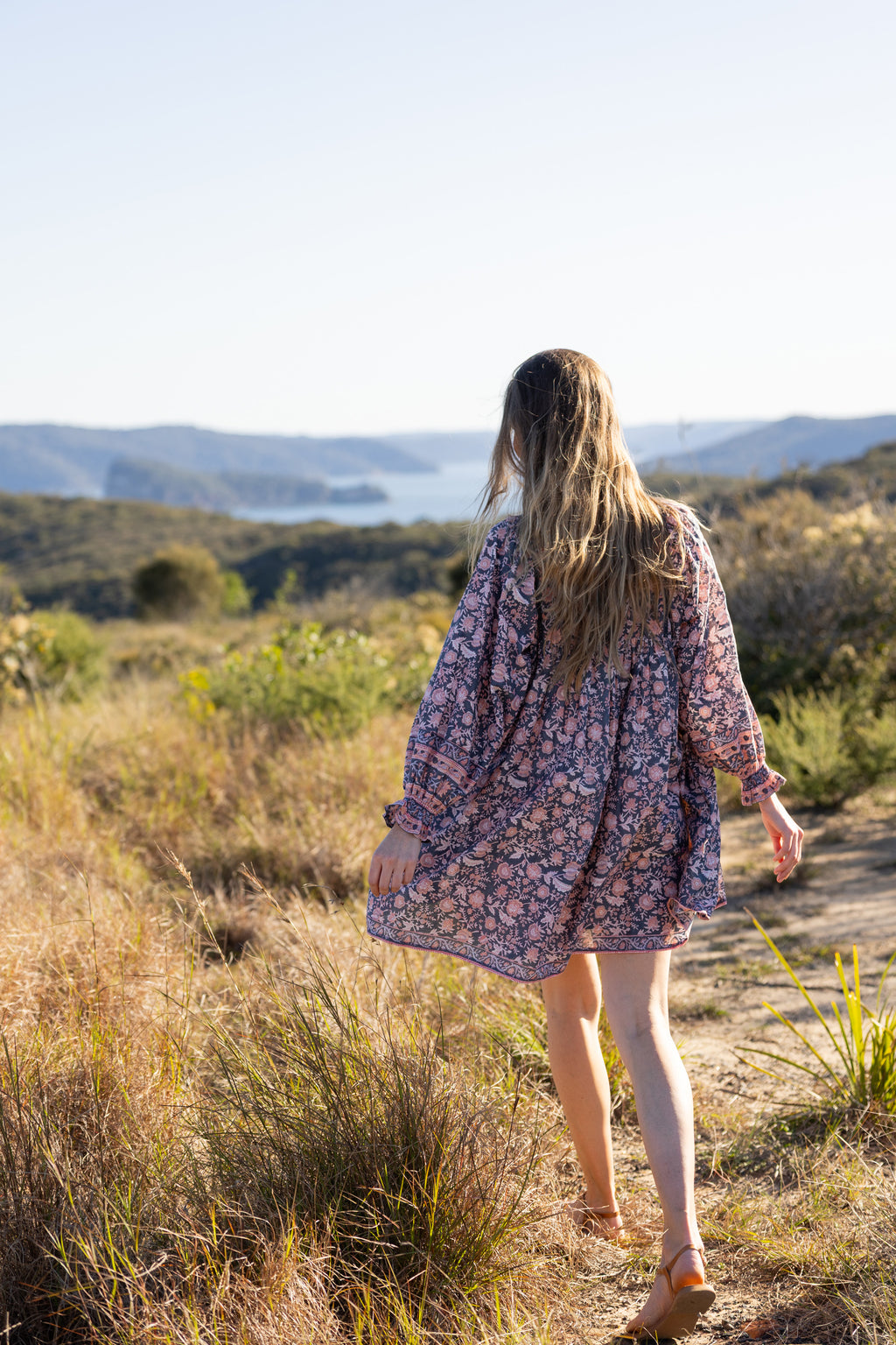 Made by Mortals women’s Jardin de Rose Mini Dress with billowy sleeves, hand block printed cotton bohemian dress in black with white, blue and pink floral pattern.