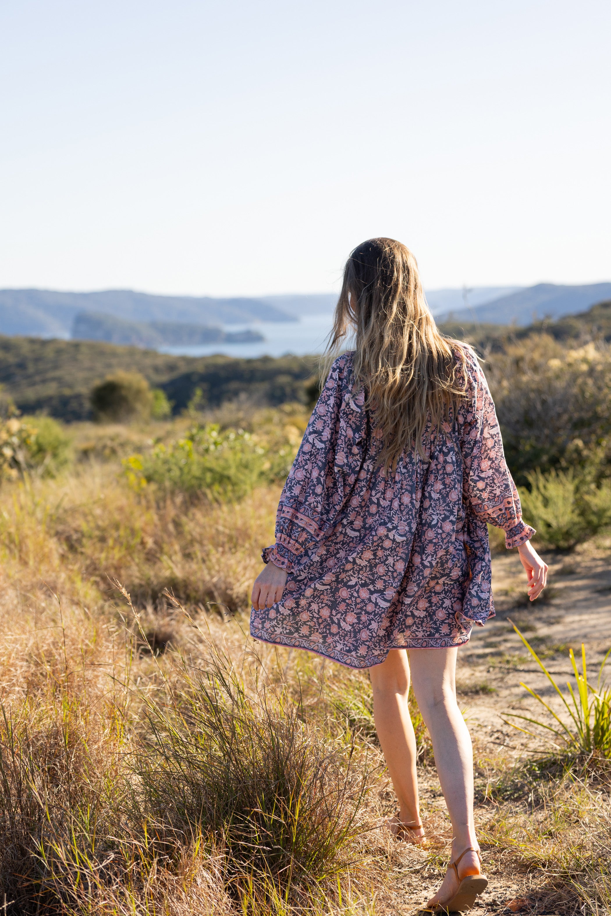 Made by Mortals women’s Jardin de Rose Mini Dress with billowy sleeves, hand block printed cotton bohemian dress in black with white, blue and pink floral pattern.
