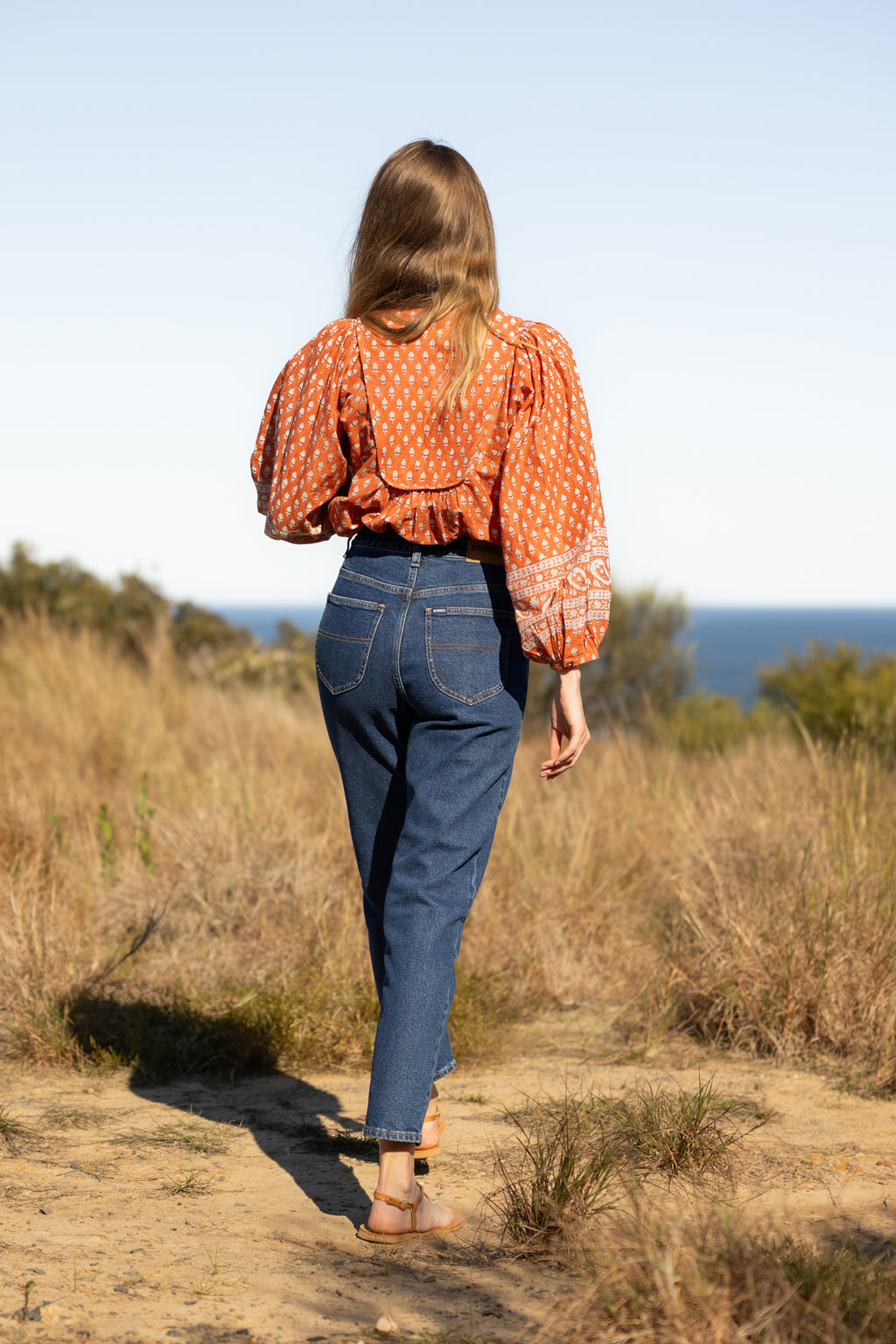 Made by Mortals women’s Desert Bloom Blouse with billowy sleeves, hand block printed bohemian cotton blouse in rust.