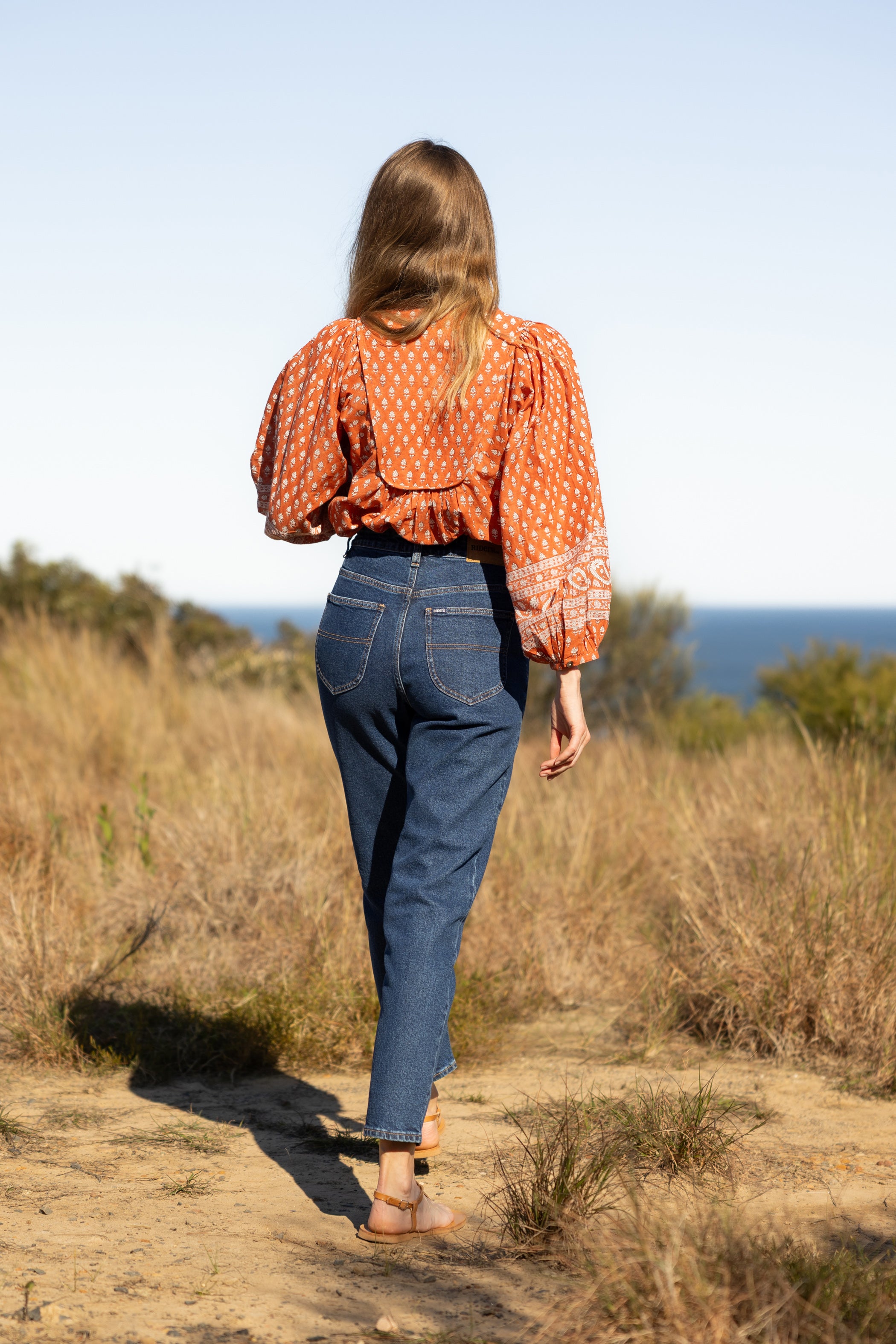 Made by Mortals women’s Desert Bloom Blouse with billowy sleeves, hand block printed bohemian cotton blouse in rust.