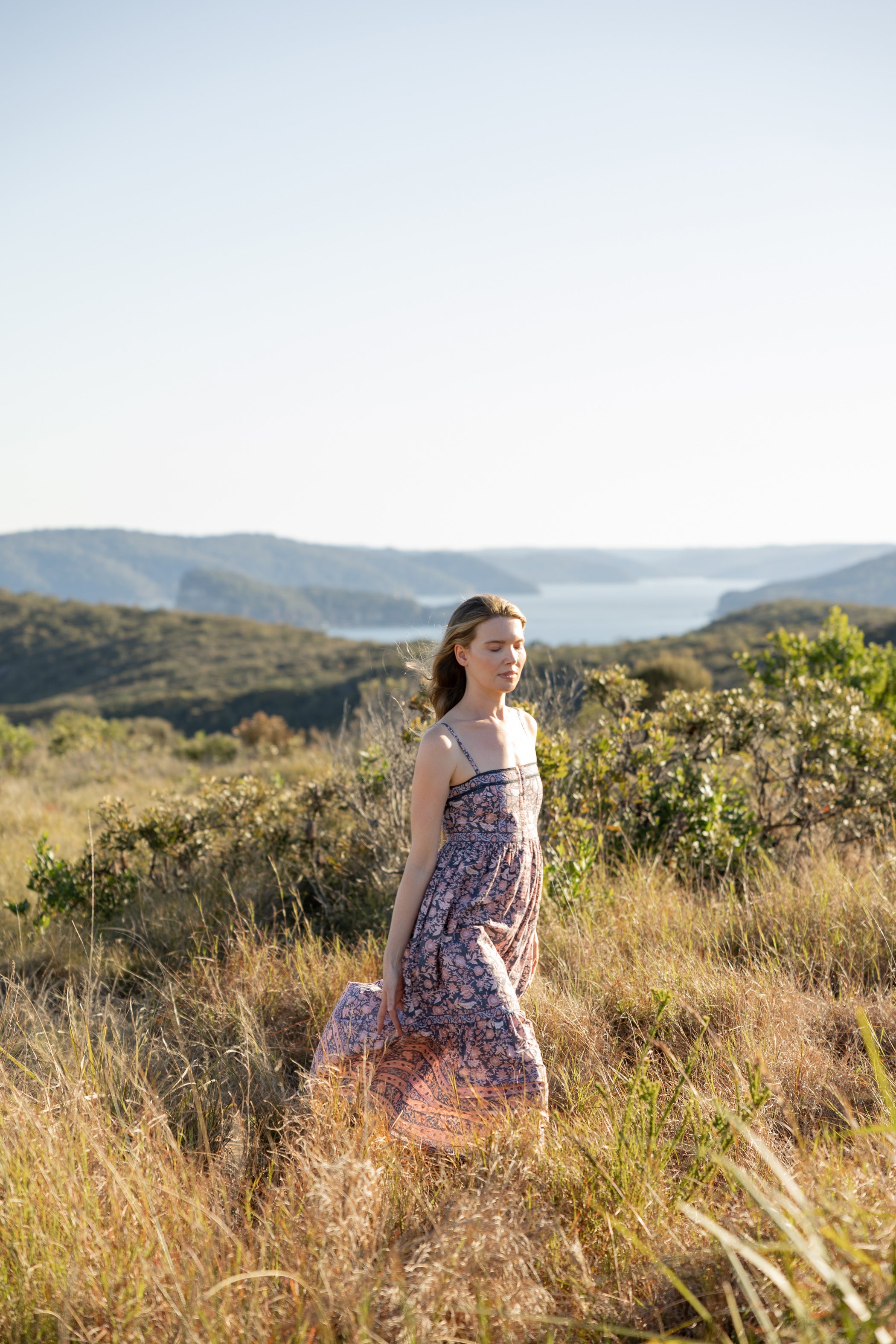 Made by Mortals women’s Jardin de Rose Midi Dress, bohemian strappy dress in black with white, blue, and pink floral, hand block printed cotton.