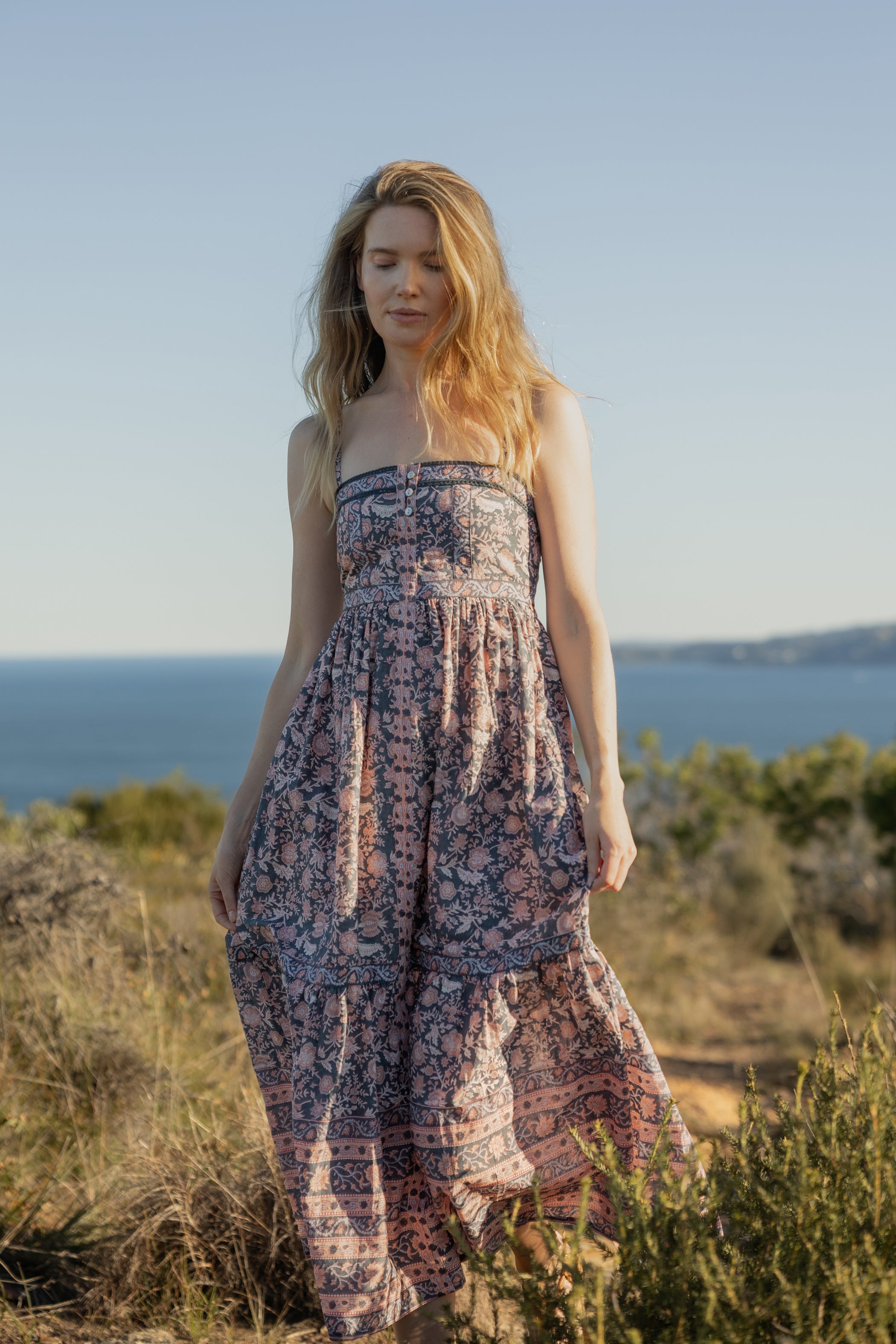 Made by Mortals women’s Jardin de Rose Midi Dress, bohemian strappy dress in black with white, blue, and pink floral, hand block printed cotton.