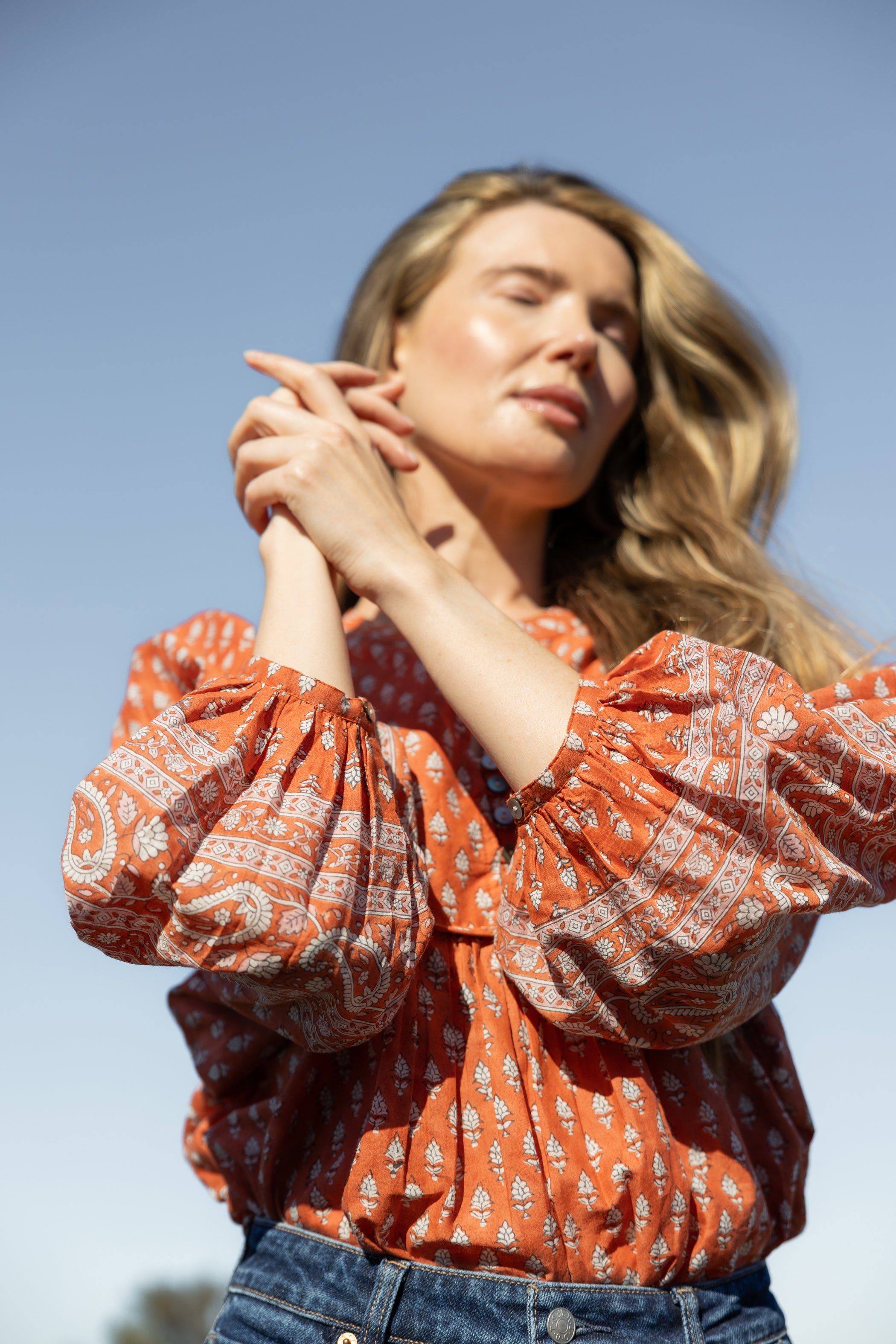 Made by Mortals women’s Desert Bloom Blouse with billowy sleeves, hand block printed bohemian cotton blouse in rust.