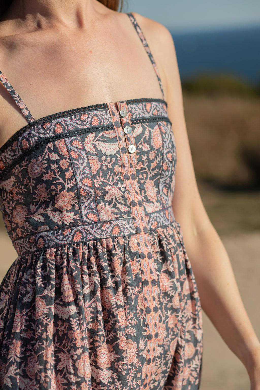 Made by Mortals women’s Jardin de Rose Midi Dress, bohemian strappy dress in black with white, blue, and pink floral, hand block printed cotton.