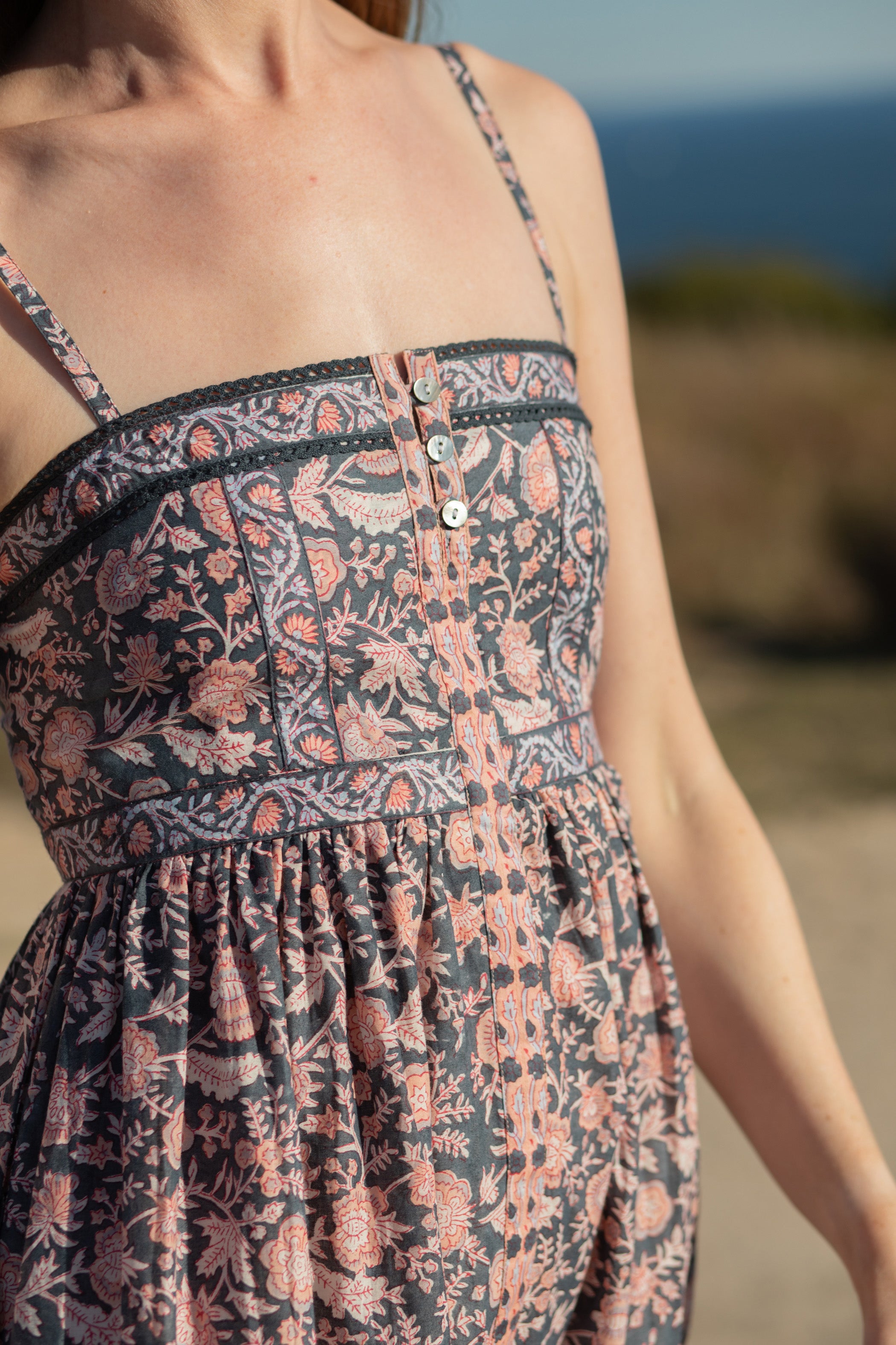 Made by Mortals women’s Jardin de Rose Midi Dress, bohemian strappy dress in black with white, blue, and pink floral, hand block printed cotton.