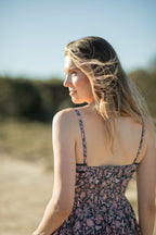 Made by Mortals women’s Jardin de Rose Midi Dress, bohemian strappy dress in black with white, blue, and pink floral, hand block printed cotton.