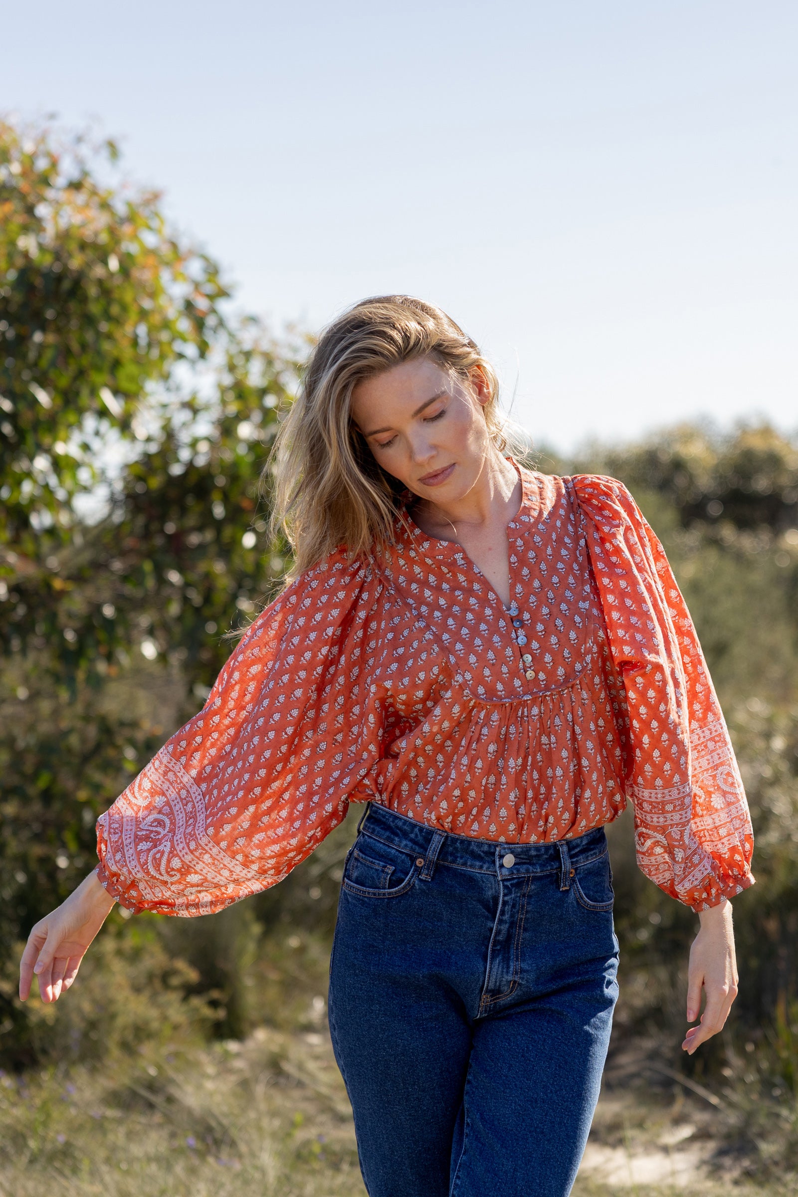 Made by Mortals women’s Desert Bloom Blouse with billowy sleeves, hand block printed bohemian cotton blouse in rust.