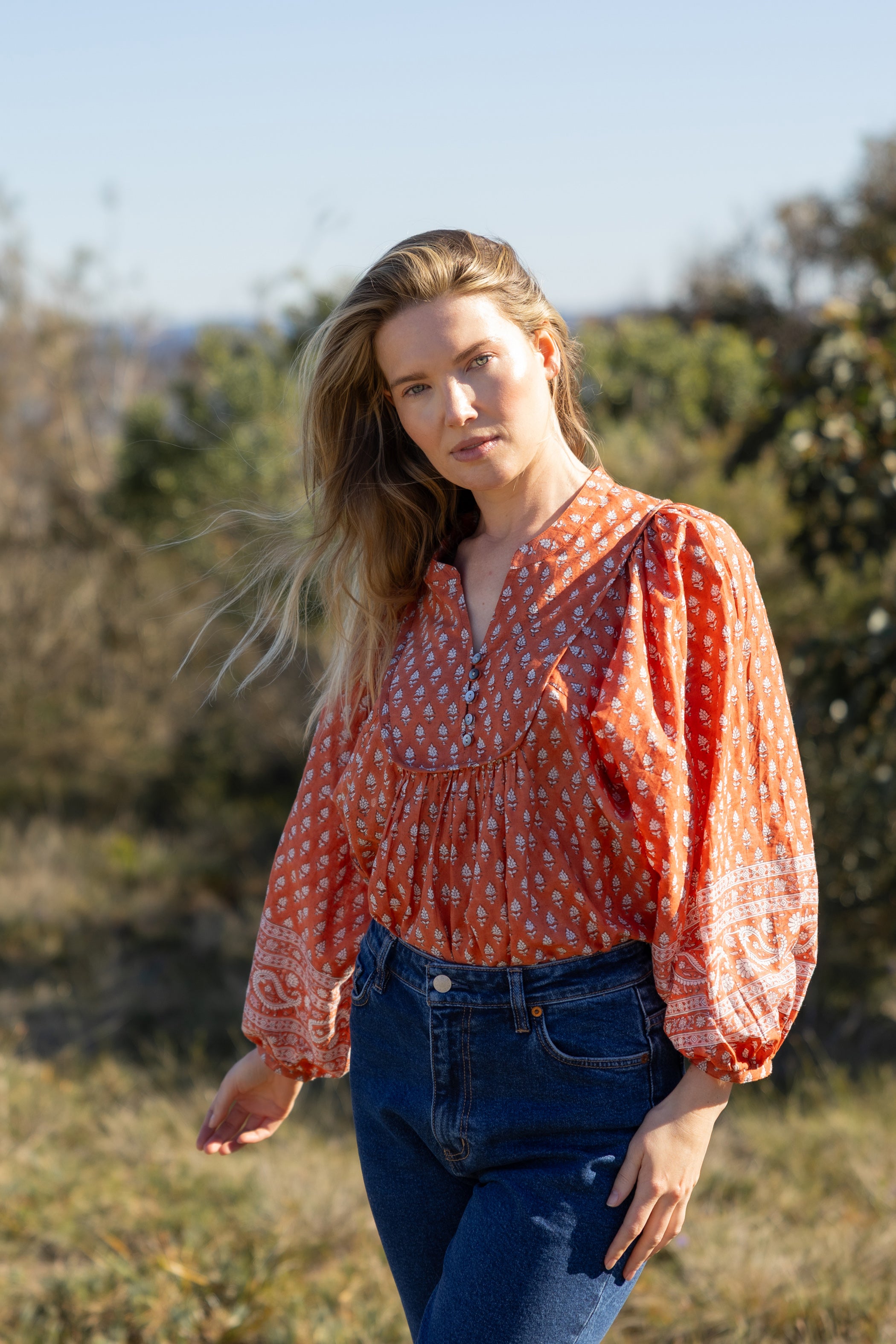 Made by Mortals women’s Desert Bloom Blouse with billowy sleeves, hand block printed bohemian cotton blouse in rust.