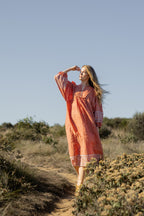 Made by Mortals women’s Desert Bloom Midi Dress in rust with billowy sleeves, hand block printed cotton bohemian dress by artisans in India.