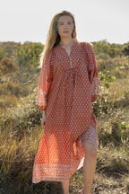 Made by Mortals women’s Desert Bloom Midi Dress in rust with billowy sleeves, hand block printed cotton bohemian dress by artisans in India.