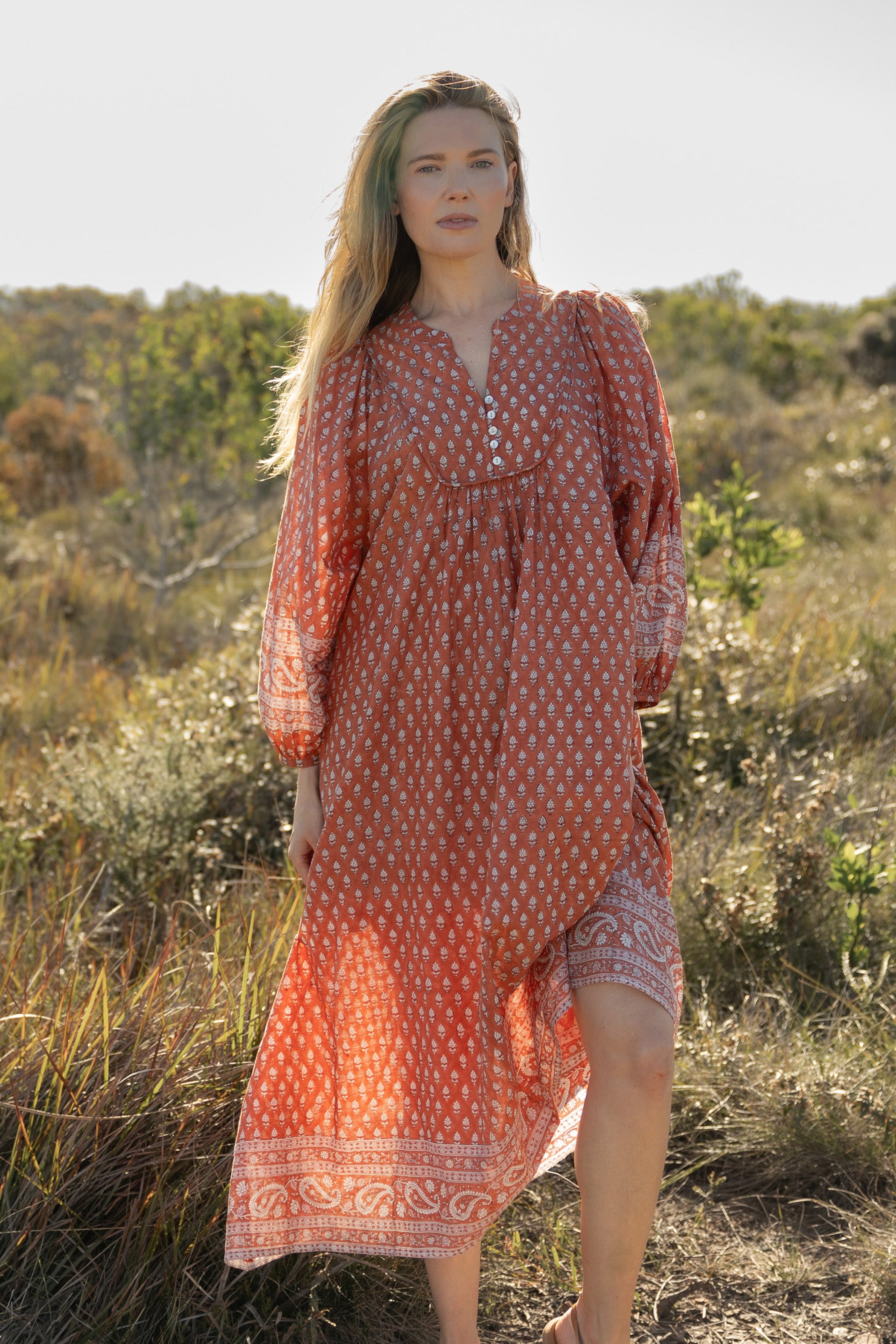 Made by Mortals women’s Desert Bloom Midi Dress in rust with billowy sleeves, hand block printed cotton bohemian dress by artisans in India.