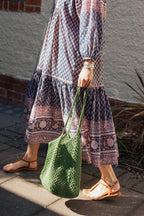 Sorrento Crochet Tote, a lightweight cotton crochet bag in green worn with hand block print cotton dress.