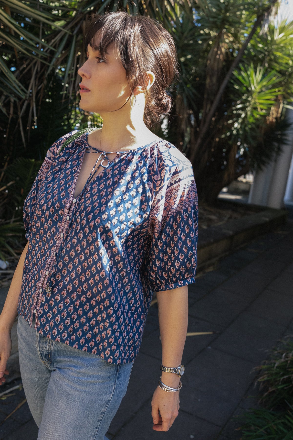 Woman wearing the Lisette navy hand block printed blouse with jeans.