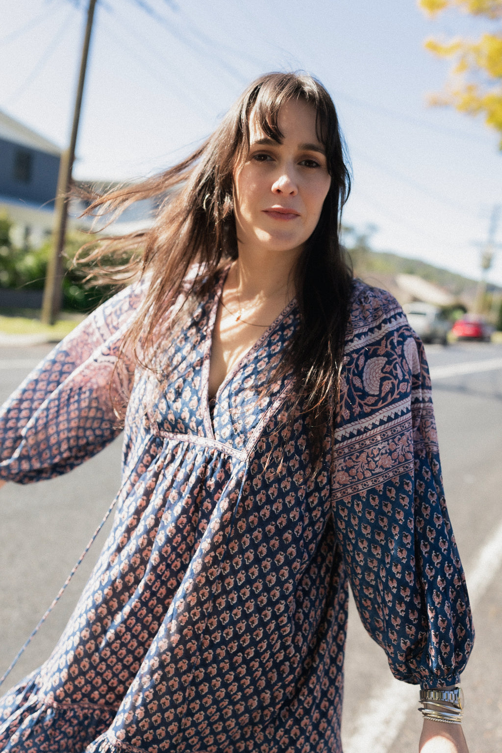 Woman wearing the Lisette Midi Dress, a navy and soft nude hand block print cotton midi dress.